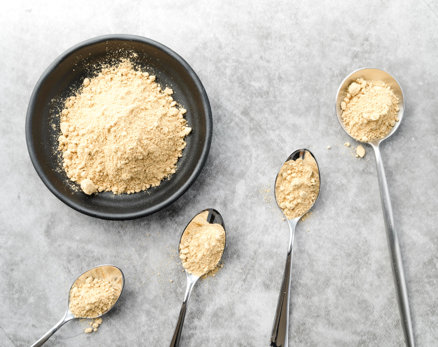 vegan protein powder on plate with spoons