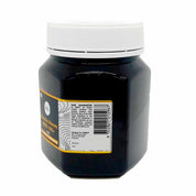 Black jar with white lid and yellow label of Orku’s Manuka Honey, 100% raw and pure