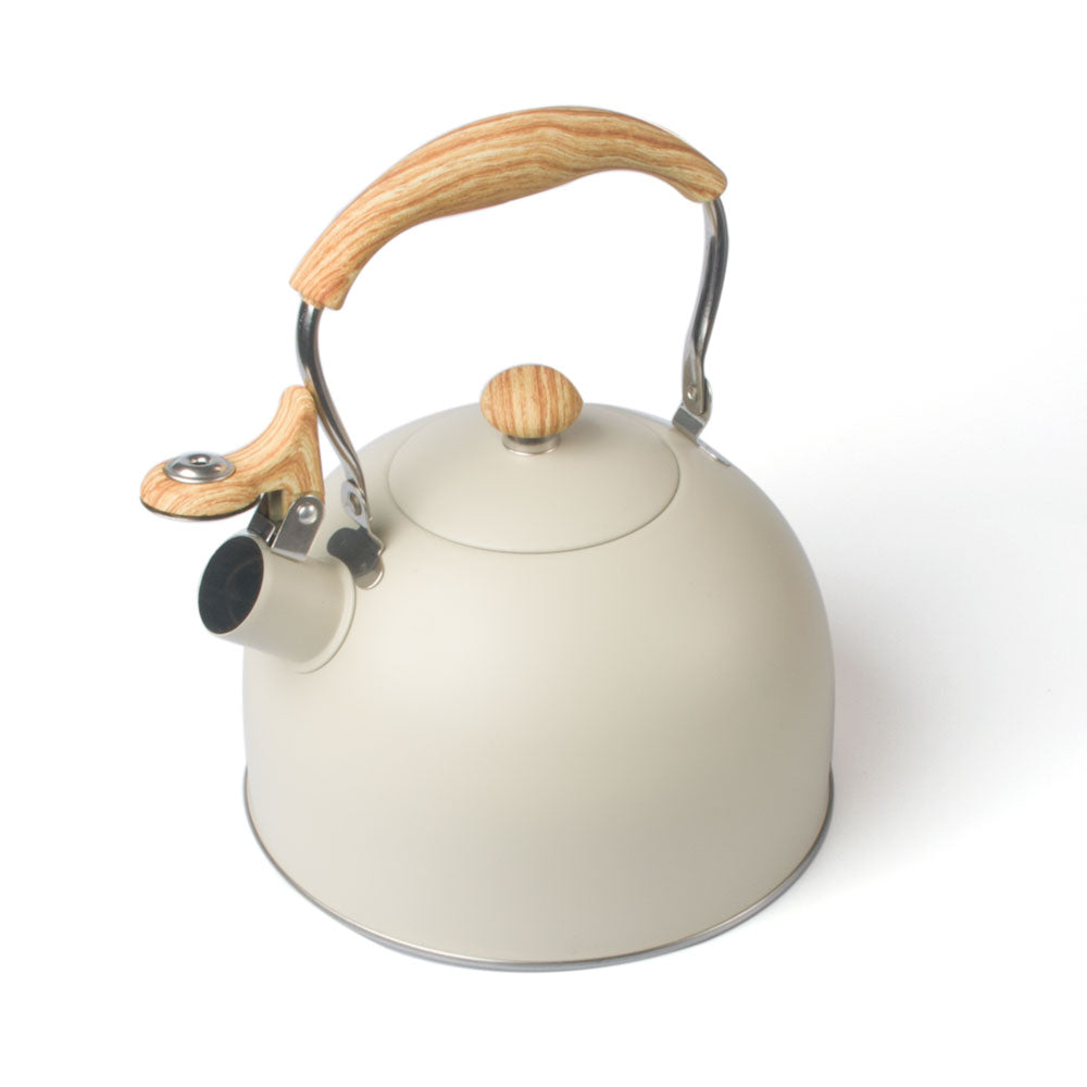 Cream-colored tea whistling kettle with wooden handle in modern stainless steel design