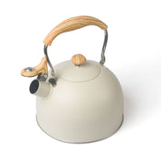 Cream-colored tea whistling kettle with wooden handle in modern stainless steel design