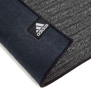 Black Adidas Hot Yoga Mat with textured surface and webbed non-slip base for Bikram yoga