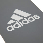 White Adidas logo on gray surface of Adidas Pilates Bands for yoga resistance training