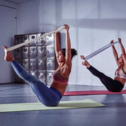 Participants in an exercise class using Adidas Premium Yoga Strap for V-hold poses