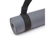 Gray yoga mat with black Adidas shoulder carry strap for easy transport