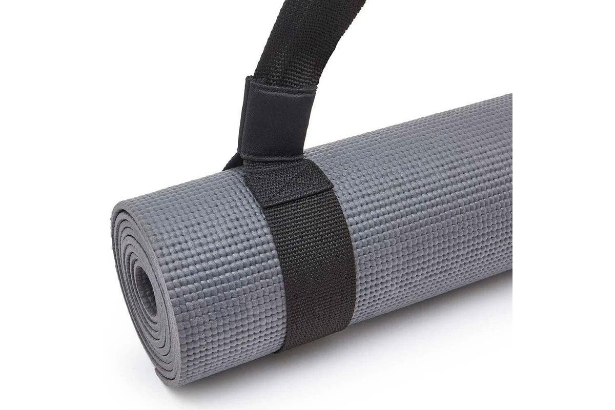 Gray yoga mat with black Adidas shoulder carry strap for easy transport