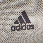 Black Adidas logo on textured fabric of Adidas Yoga Mat Carrier Bag with adjustable strap