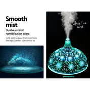 Glowing turquoise Devanti Aroma Diffuser with 3D glass and mist for aromatherapy