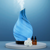 Blue swirled glass Devanti Ultrasonic Aroma Diffuser emitting vapor with LED night light