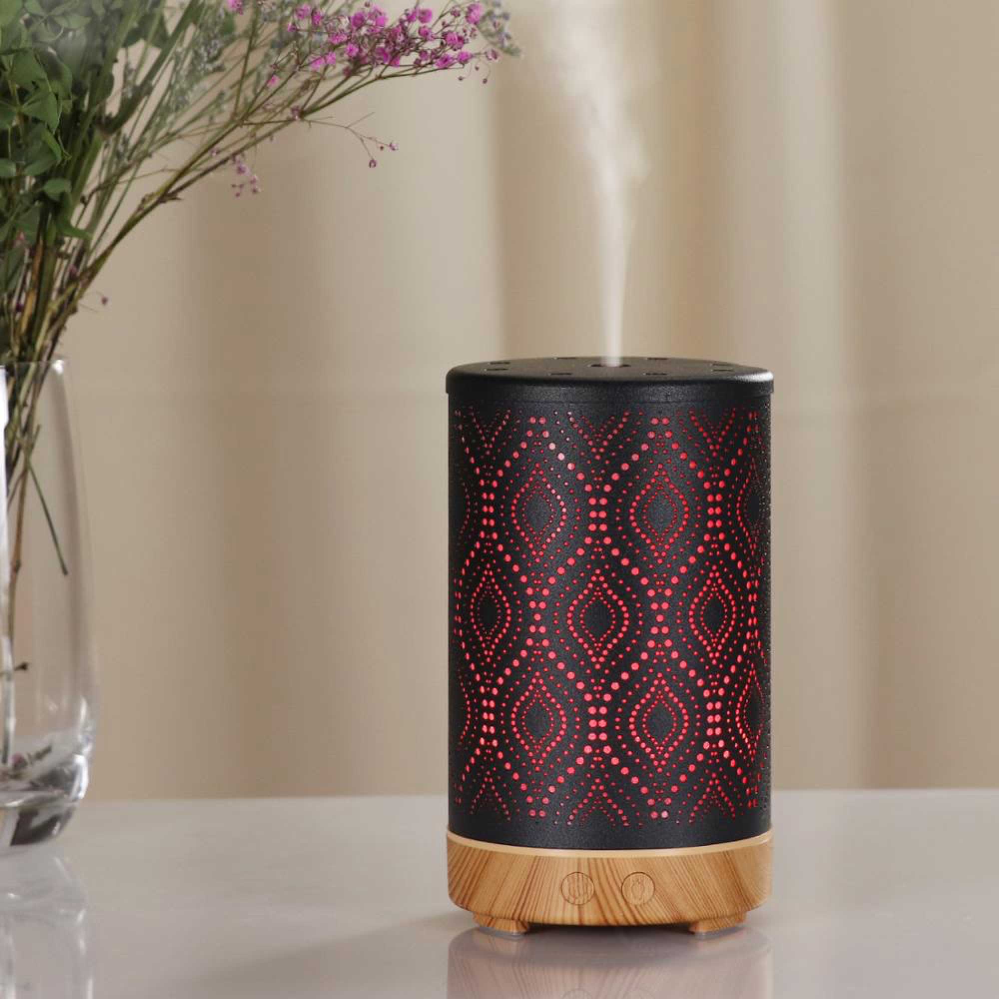 Metal and wood essential oil diffuser with geometric cutouts emitting ultrasonic aroma steam