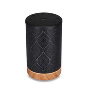 Black metal diffuser with geometric pattern and wood grain base for essential oils