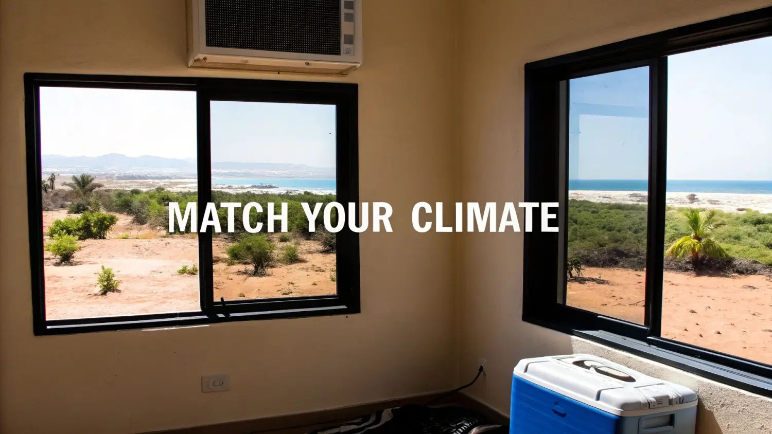 A room with air conditioning and a cooler, overlooking a hot, dry coastal landscape.