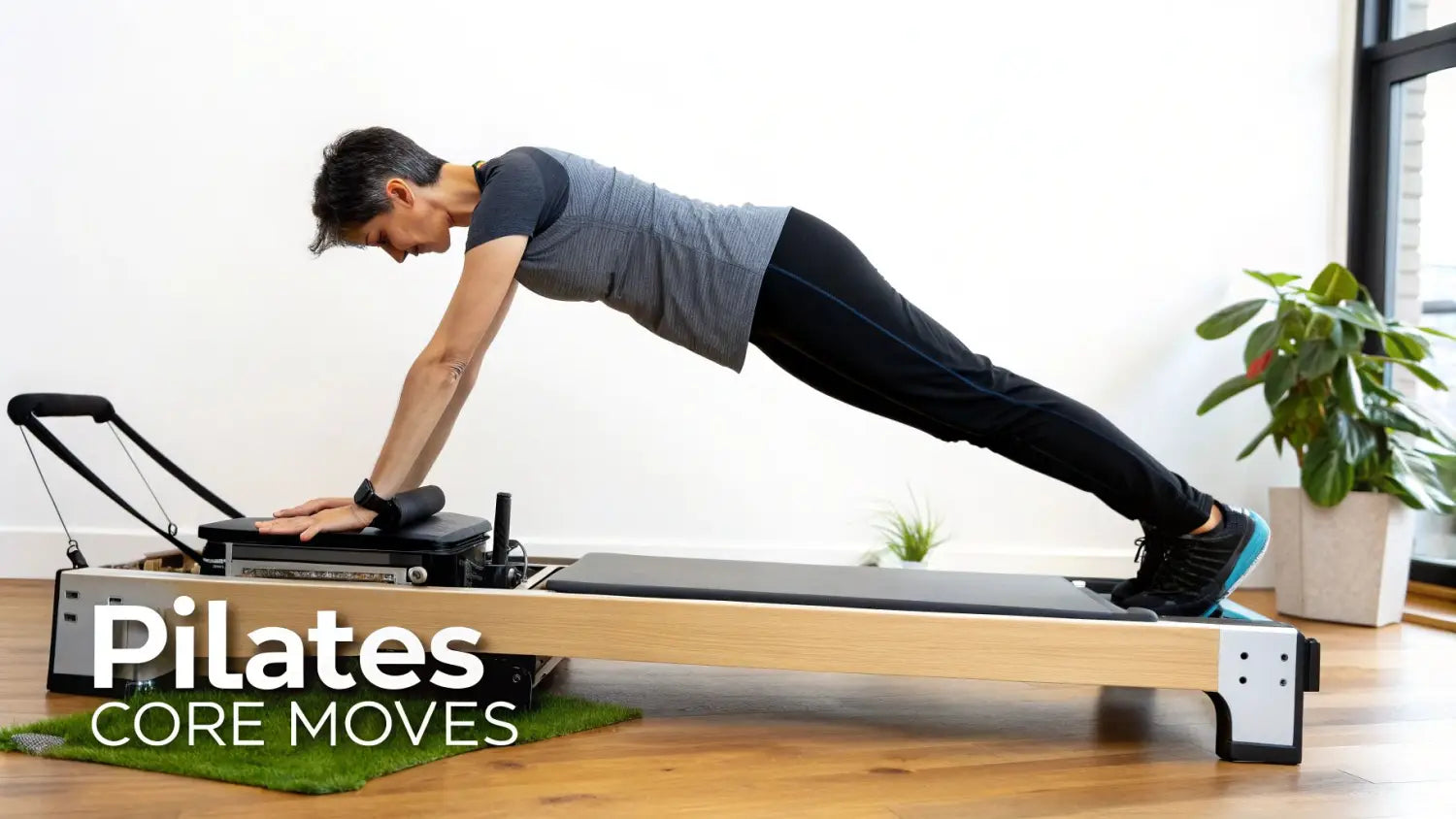 A woman performing a plank exercise on a foldable Pilates reformer machine.