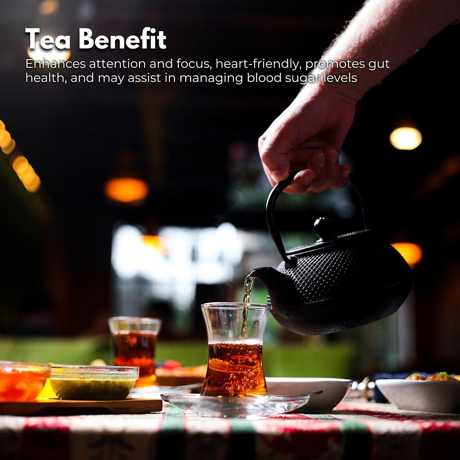 Black cast iron Gominimo 1200ML iron teapot set pouring tea into a glass cup