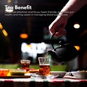 Black cast iron Gominimo 1200ML iron teapot set pouring tea into a glass cup