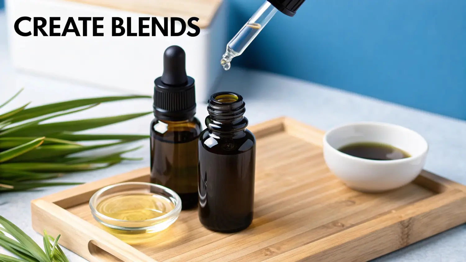 A dropper adding essential oil to a dark bottle, with other essential oil bottles and bowls on a wooden tray.