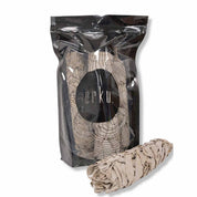 Black packaging bag featuring a White Sage Smudge bundle from Coastal Mountains