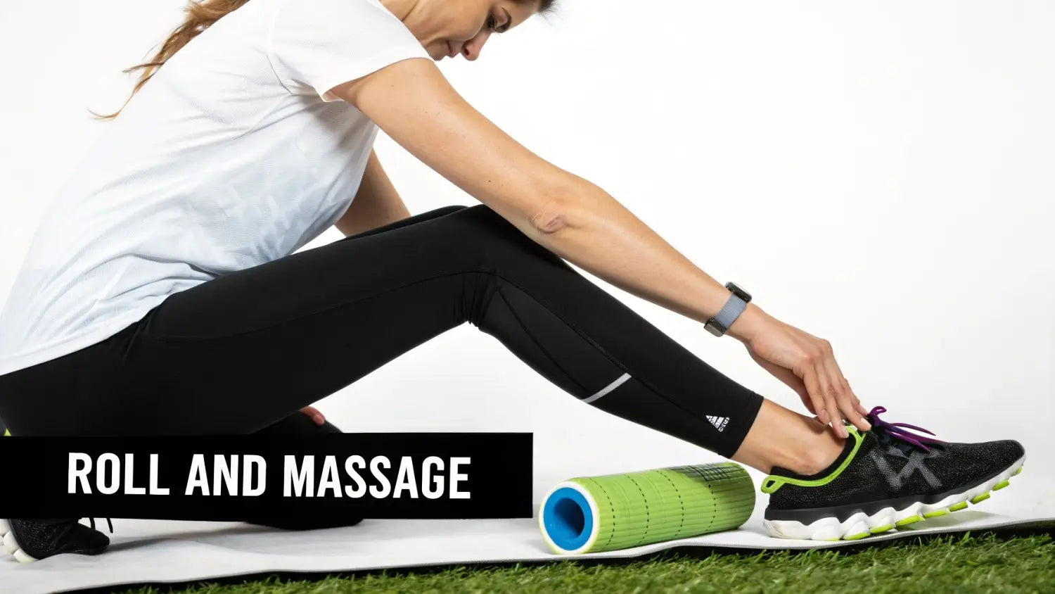 Woman in athletic wear adjusting her running shoe, with a foam roller nearby on a yoga mat.