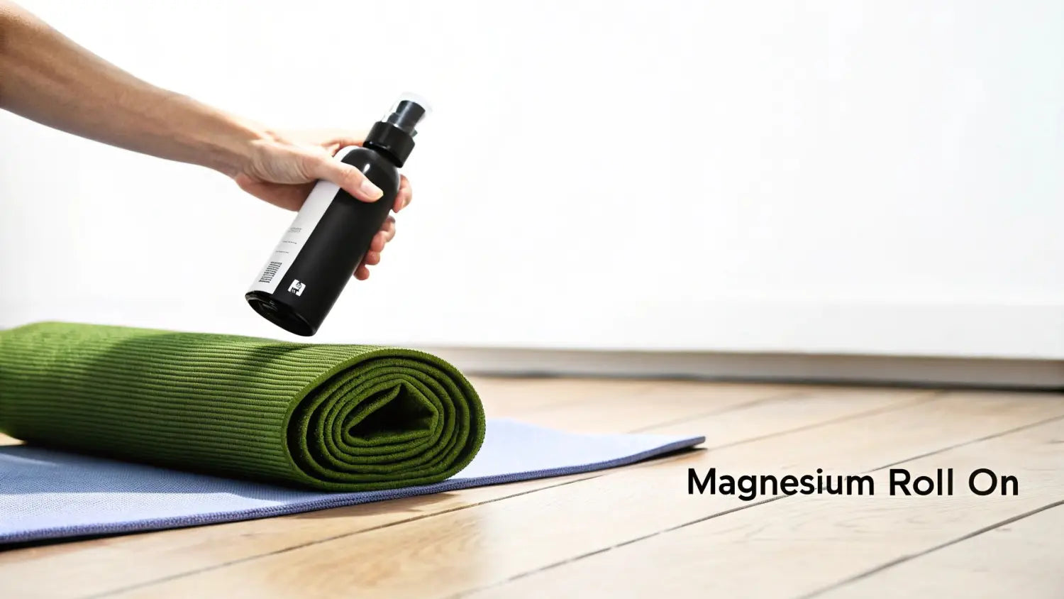 Person's hand applying magnesium spray over a green yoga mat, ready for exercise or recovery.
