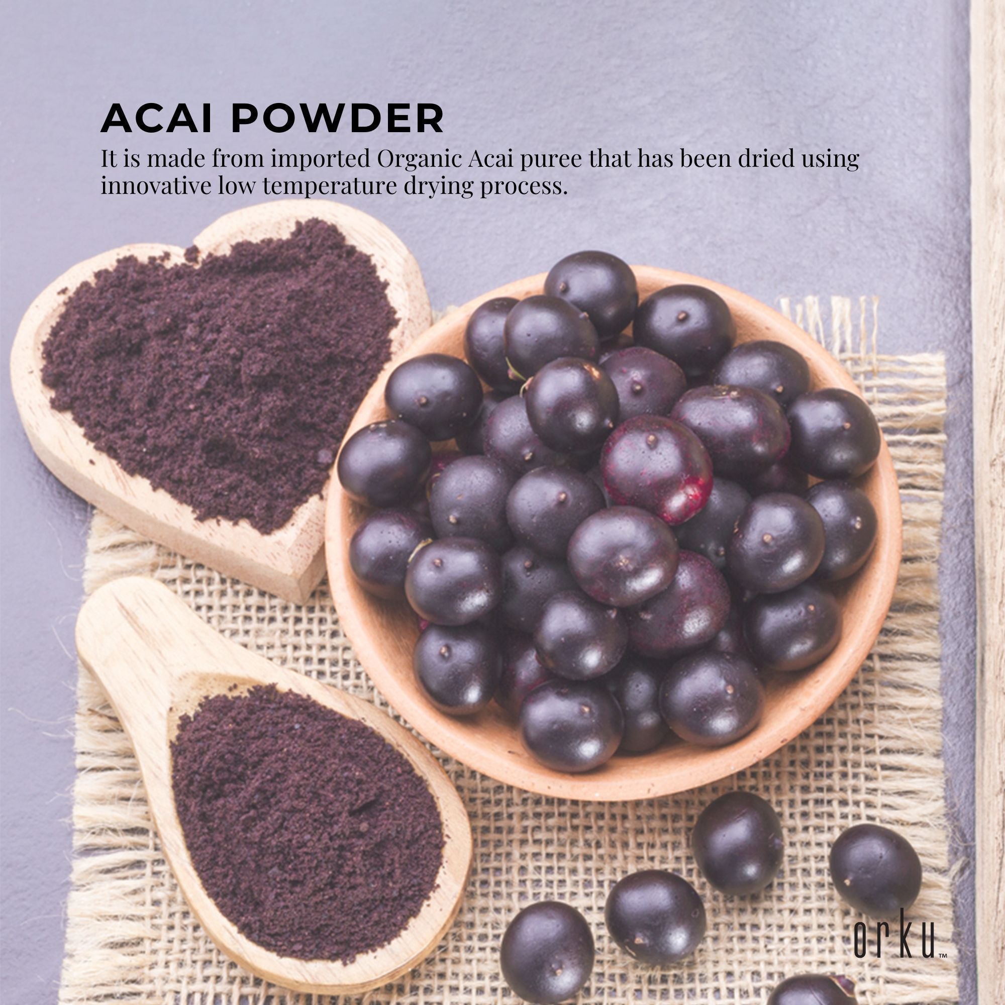 whole acai berries in bowl next to powder