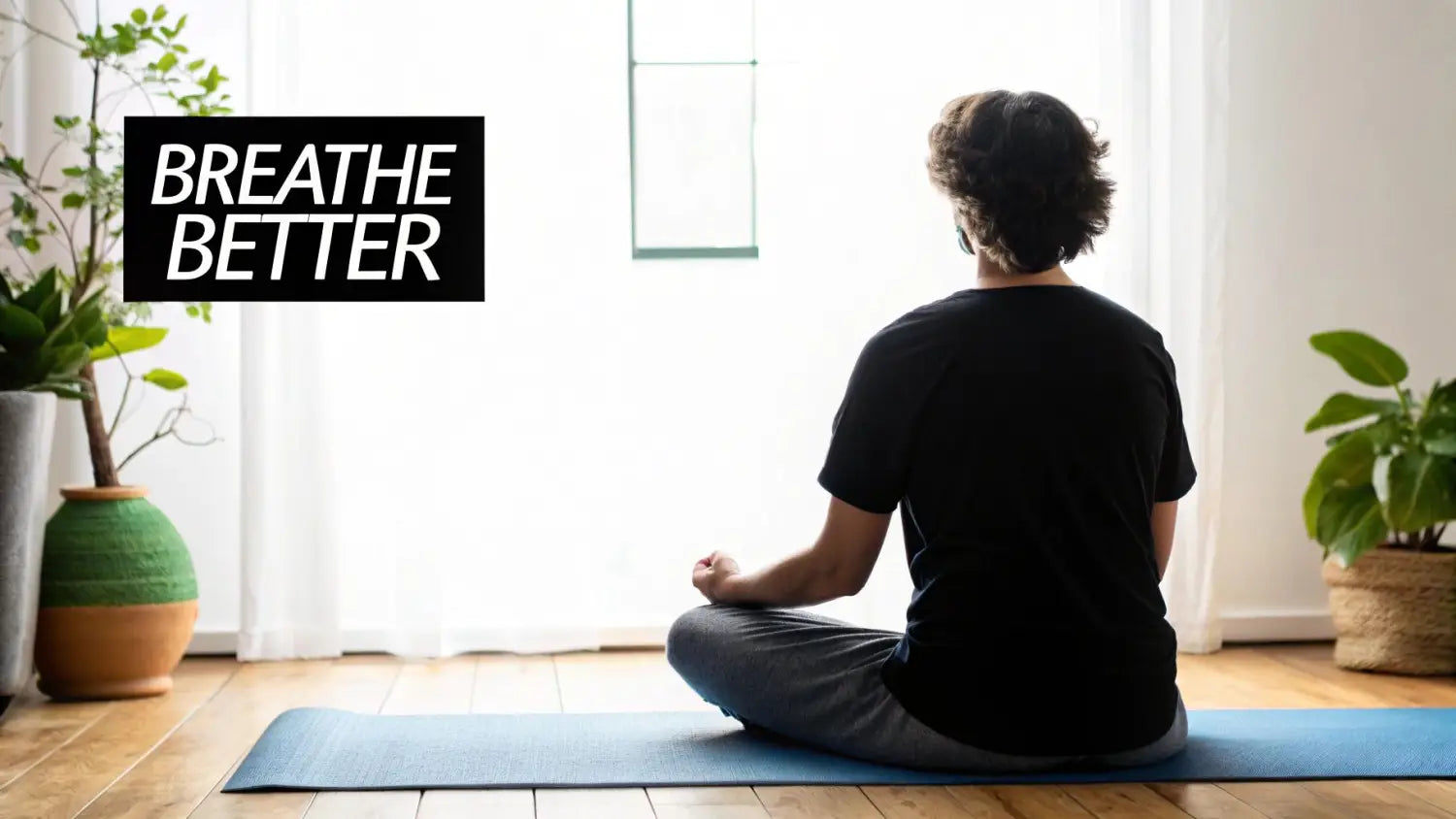 A person meditates on a blue yoga mat facing a bright window, surrounded by plants. Text reads 'Breathe Better'.