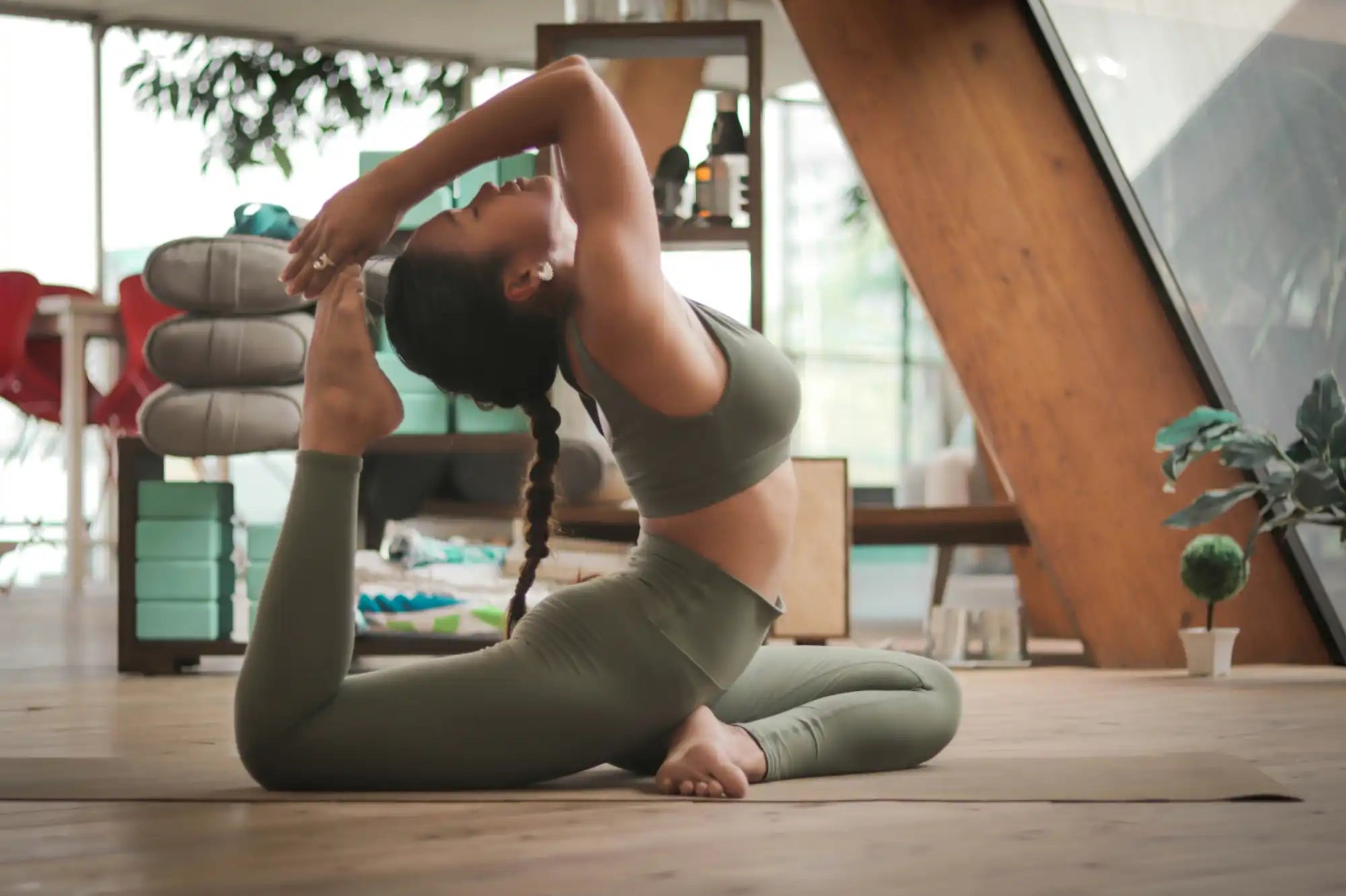 A person performing a yoga backbend pose on a mat.