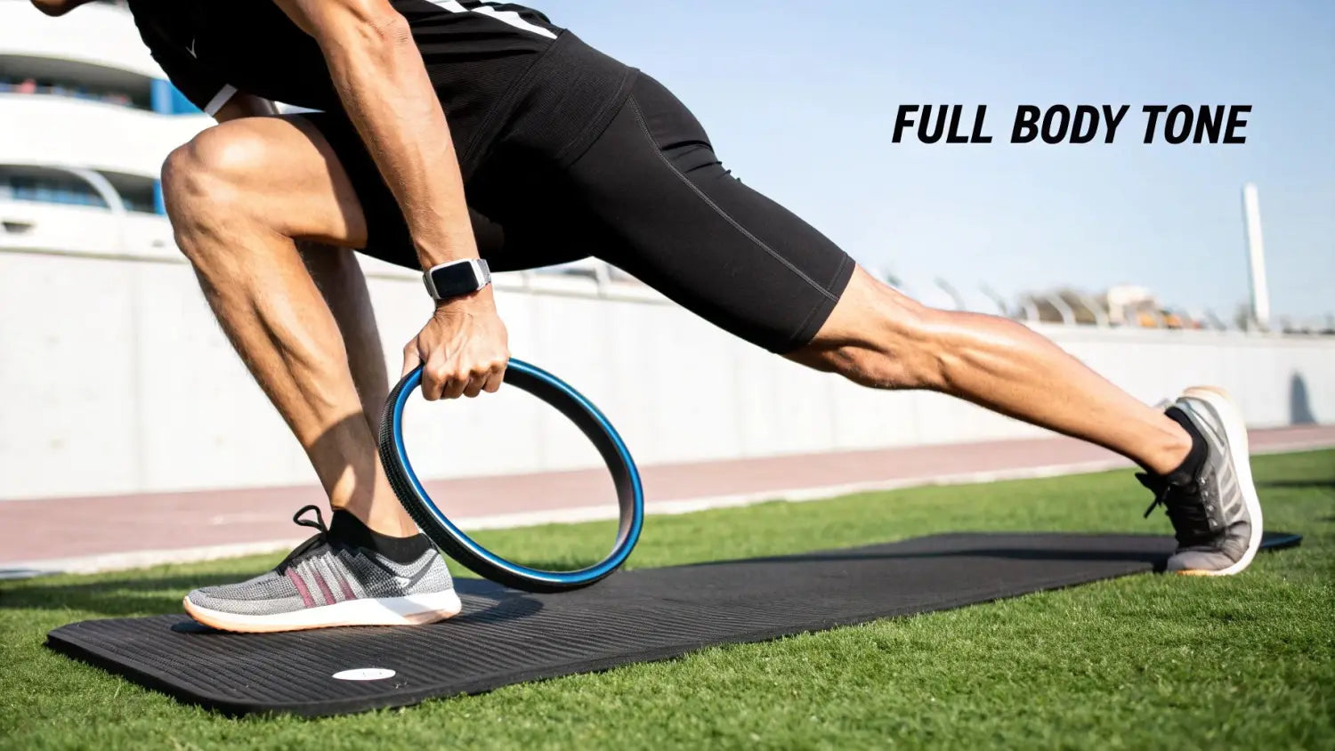 Man performing a lunge exercise with a blue pilates ring on a mat outdoors, showcasing full body tone.