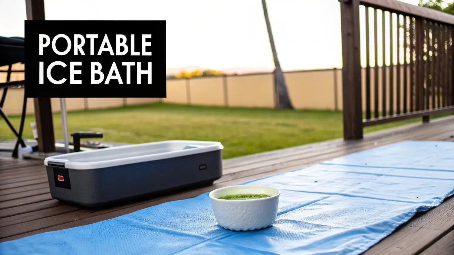 A portable ice bath container, a bowl of green liquid, and a blue mat on a wooden deck outdoors.
