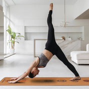 Yoga practitioner in three-legged downward dog on Powertrain Cork Yoga Mat