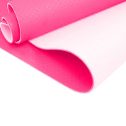 Curled pink foam sheet showcasing the non-slip surface of Dual Layer 8mm Yoga Mat