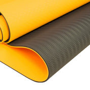 Yellow and black anti-fatigue mat with textured surface for the Powertrain Dual Layer 8mm Yoga Mat