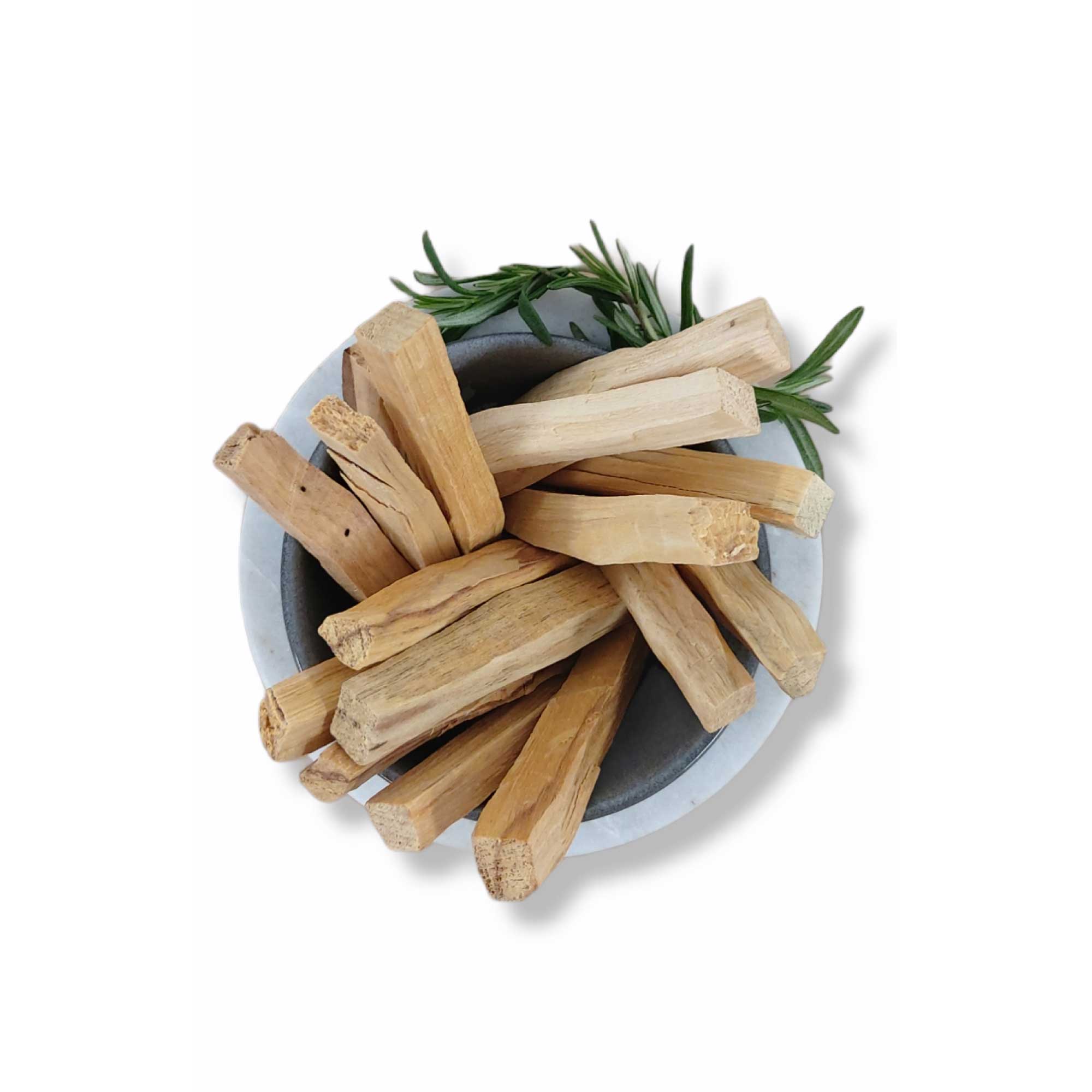 Dried Palo Santo smudge sticks bundled with green leaves for cleansing rituals