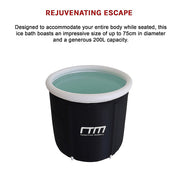 Cylindrical black and white portable ice bath with turquoise water for cold water therapy