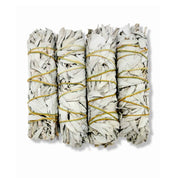 Four white sage smudge sticks bound with natural twine for cleansing rituals