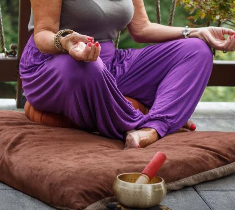 woman meditating with singing bowl