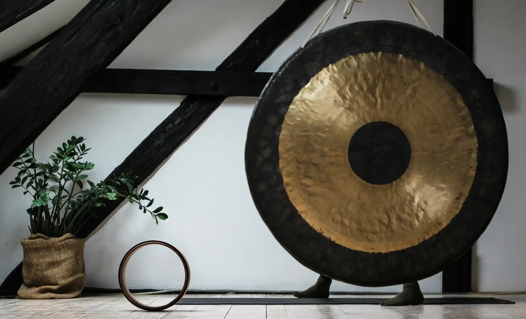 Traditional Chinese gong with a black frame and brass-colored center.