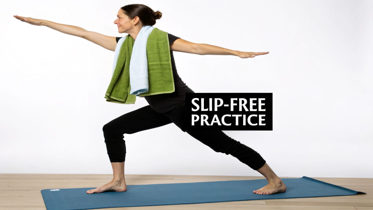 Woman in a yoga pose on a mat with two towels, demonstrating a slip-free practice.