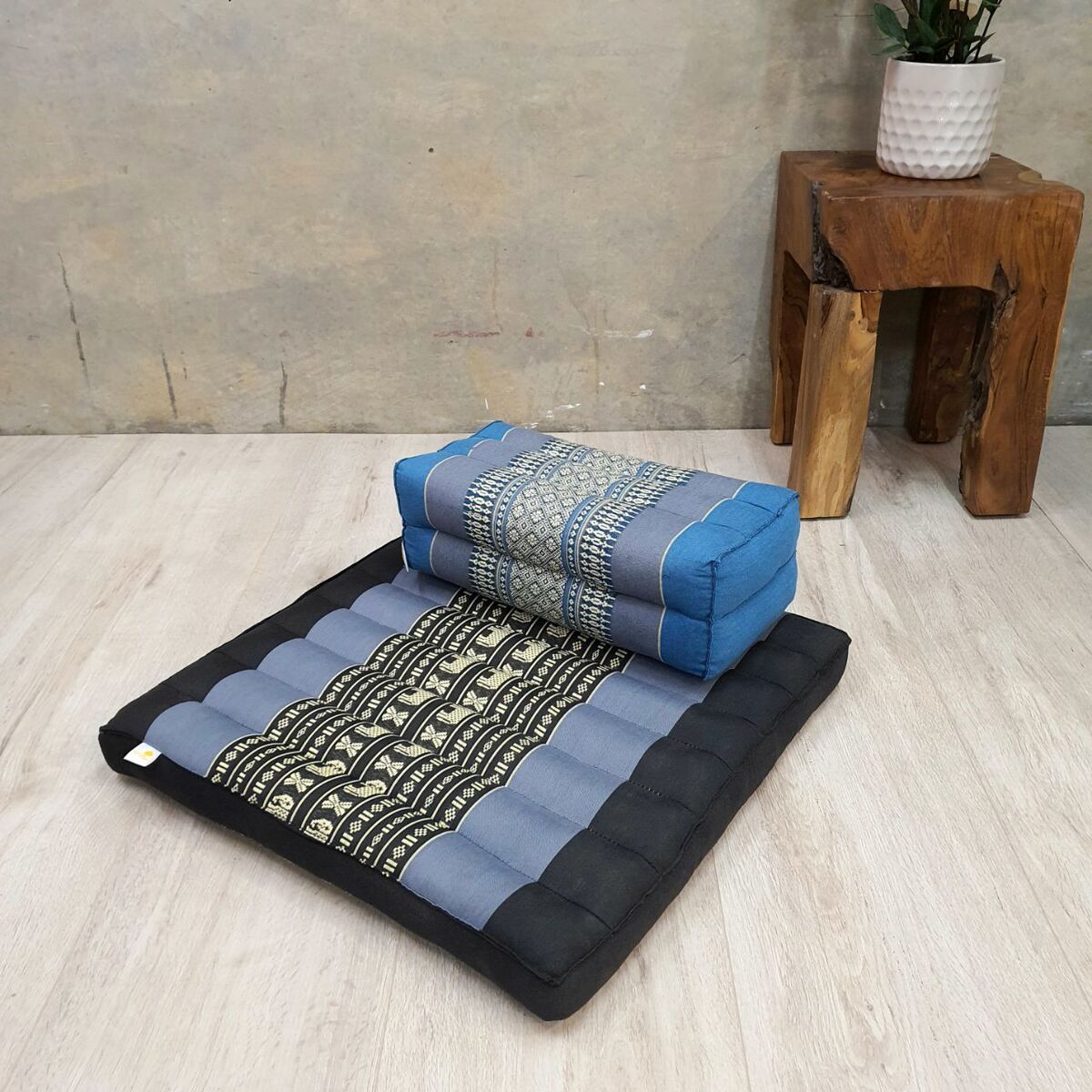 black and blue floor cushion and blue yoga seat block