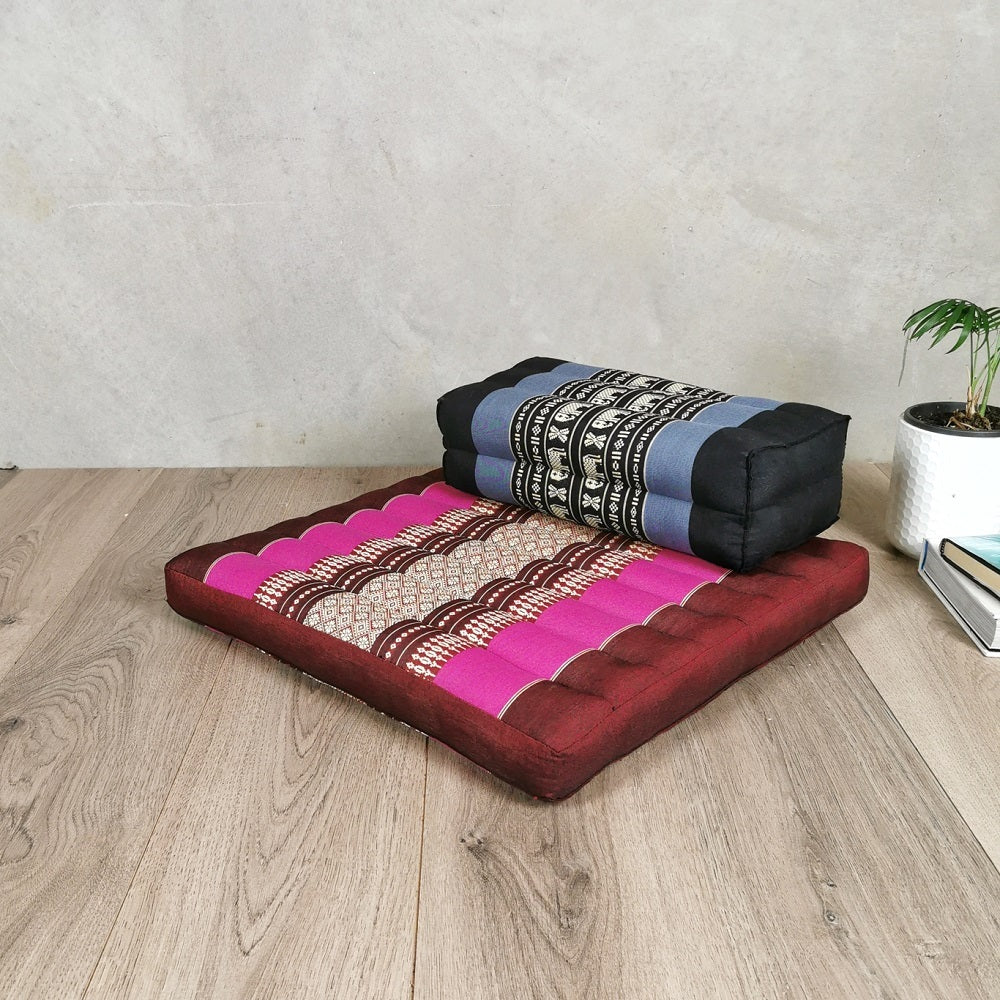 red and pink meditation cushion and black and blue yoga seat block